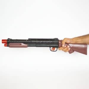 a hand is holding airsoft toy shotgun